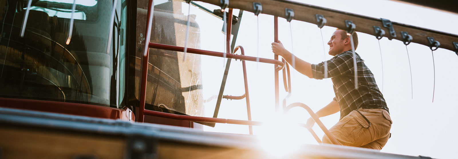 Farmer climbing into a combine.