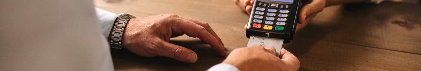 man paying at credit card reader