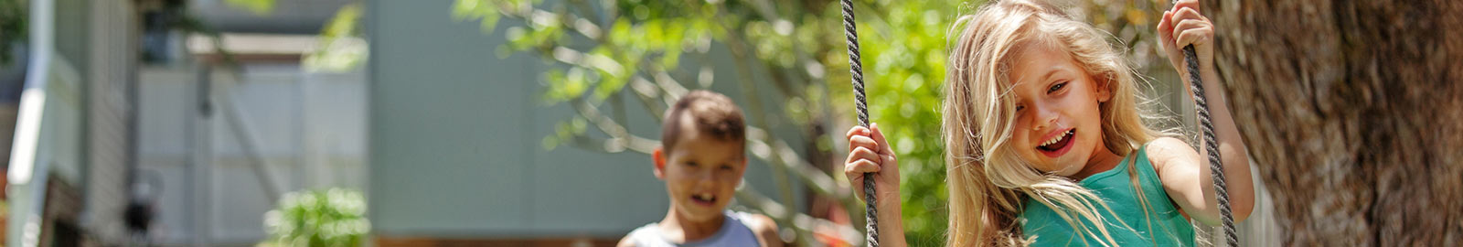 Girl swinging in backyard.